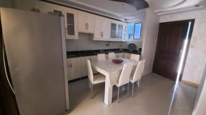 a kitchen with a table and chairs in a room at شقة الكرنيش in Nador