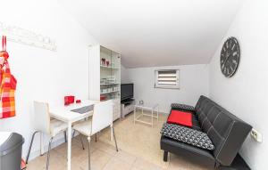 a living room with a table and a couch and a desk at Cozy Apartment In Labin With Wifi in Labin