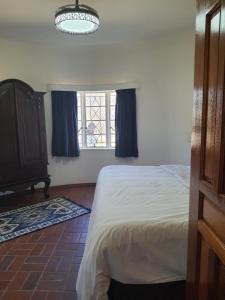 a bedroom with a bed and a window at Mzila Forest Creek in Maanhaarrand