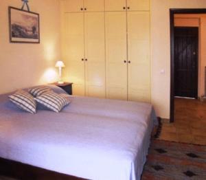 a bedroom with a bed with two pillows on it at Sea Front in Milina