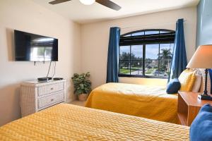 a bedroom with two beds and a window at Golf getaway fun for family and friends for an Orlando theme park vacation in Davenport