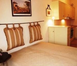 a bedroom with a bed withpillows on the wall at Sea Front in Milina