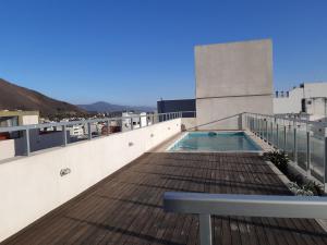 a rooftop deck with a swimming pool on a building at Departamentos Giovanni in Salta