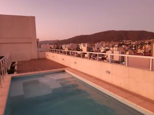 a swimming pool on the roof of a building at Departamentos Giovanni in Salta