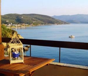 a balcony with a table with a view of the water at Sea Front in Milina