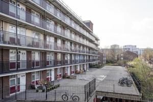 a large building with a parking lot in front of it at 1 Bedroom Flat Close to City with Free Parking Arrangement in London