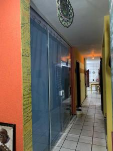 a hallway with a glass door in a building at Parnaíba Hostel in Parnaíba