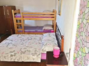 a small bedroom with two bunk beds and a table at Apartments and rooms by the sea Stara Novalja, Pag - 11626 in Novalja