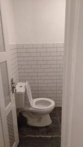 een badkamer met een wit toilet in een kamer bij Villa Kebun Prambanan in Randugunting
