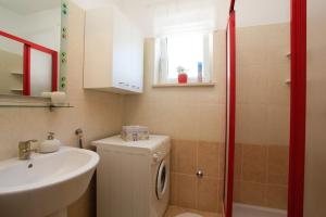 a bathroom with a sink and a washing machine at Holiday house with a parking space Premantura, Medulin - 11631 in Premantura +20 photos