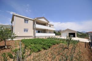 a villa with a view of a house at Apartments with a parking space Plano, Trogir - 11649 in Trogir