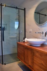 a bathroom with a sink and a glass shower at Mariner Rose B&B in Stanley