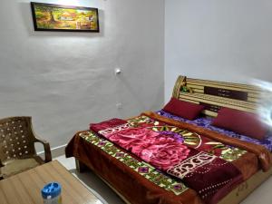 a bedroom with a bed with pink roses on it at WonderLand Guest House in Udhampur