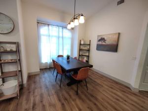 a dining room with a table and chairs and a clock at Spacious OASIS Updated Home 3 bed 2 bath -7 min to Nokomis Beach in Nokomis