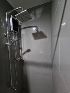 a bathroom with a shower with a laptop on the wall at Great View 1 BR Condo in Makati near Trident Tower in Manila