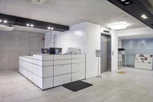 an office with a white counter with a laptop on it at Creto Hotel Myeongdong in Seoul