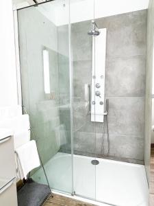 a shower with a glass door in a bathroom at Le 13 - 3min de Colmar Centre in Horbourg