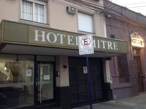 a hotel sign in front of a building with a no parking sign at Hotel Mitre in Rosario