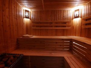 a wooden sauna with a wooden bench in it at Зона отдых APACHI в горах ЧИМГАН in Chimgan