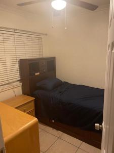 1 dormitorio con cama negra, escritorio y ventana en Home Sweet Home, en Colton