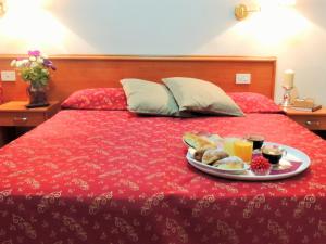 a plate of food on top of a bed at Florida rooms - comfort Hotel in Rome