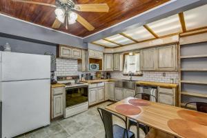 a kitchen with a table and a ceiling fan at RENU at ICT St Claire House in Wichita
