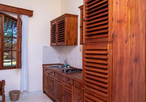 Tembo Court Apartments(Ocean Beach) في ماليندي: مطبخ مع حوض وجدار خشبي