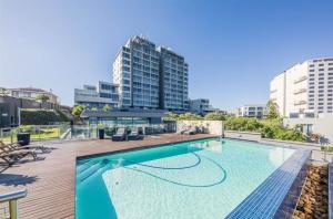 a large swimming pool on top of a building at Infinity LG3 Seaview Beach Apartment in Cape Town