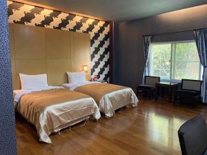 Postel nebo postele na pokoji v ubytování Treasure Island Motel - Fengshan + 20 fotografií