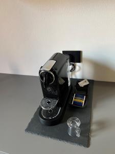 a black coffee maker sitting on a black table at Alfea Suite in Bologna