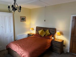 a bedroom with a bed with two night stands and two lamps at The View in Tynemouth
