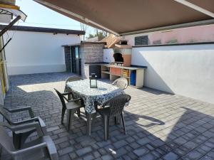 a patio with a table and chairs and a kitchen at VILLA LOBELIA in Catania