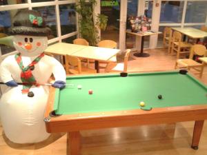 a snowman is standing next to a pool table at Fasthotel Well Inn Mâcon sud - un hôtel FH Confort in Charnay-lès-Mâcon