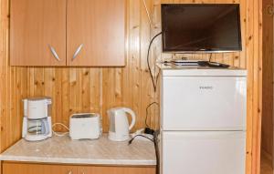 a small kitchen with a refrigerator and a microwave at Nice Apartment In Kopalino With 2 Bedrooms And Wifi in Kopalino