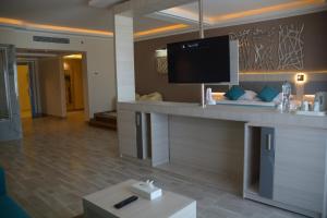 a hotel room with a reception desk with a flat screen tv at Fantazia Resort Marsa Alam in Marsa Alam City