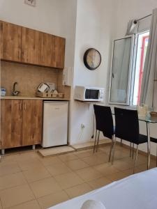a kitchen with a table and chairs and a refrigerator at City Center Apartments in Haifa