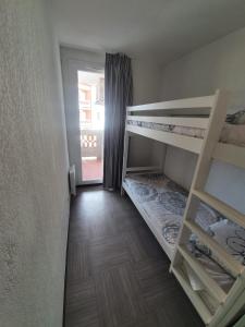 ein kleines Zimmer mit 2 Etagenbetten und einem Fenster in der Unterkunft Douceur du Verdon- Climatisé avec Piscine, Parking in Gréoux-les-Bains
