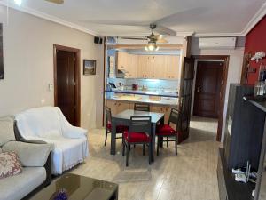 a living room with a couch and a table and a kitchen at Las Salinas in Roquetas de Mar