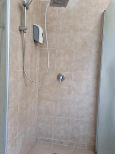 a shower with a shower head in a bathroom at City Center Apartments in Haifa