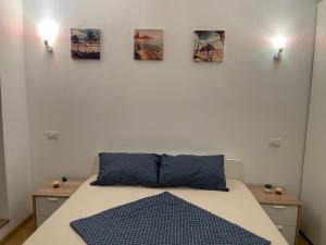 a bedroom with a bed with four pictures on the wall at Energy Luxury Apartment Near Presidential Palace in Bucharest