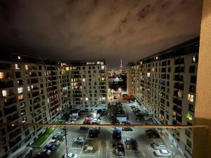 a view of a parking lot in a city at night at Energy Luxury Apartment Near Presidential Palace in Bucharest