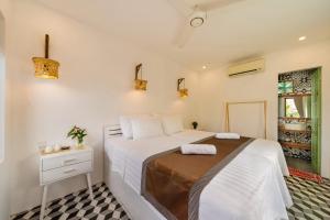 1 dormitorio con 1 cama blanca grande y vestidor en Wanderlust, en An Bàn (2)