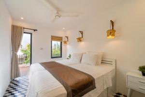 Katil atau katil-katil dalam bilik di Hoi An Wanderlust - Beachside +63 gambar