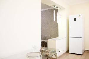a kitchen with a glass table and a refrigerator at Dilijan is for U in Dilijan