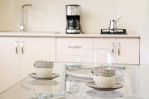 two cups of coffee on a counter in a kitchen at Dilijan is for U in Dilijan