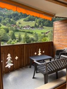 a balcony with a table and a view of a hill at Studio , Val-d’Illiez in Val-d'Illiez +2 photos