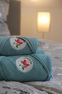 two towels sitting on top of a bed at Gemütliches Landhaus in Harmsdorf in Harmsdorf +17 photos