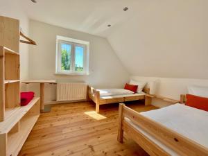 a room with two beds and a window at The Villetta in Petershausen