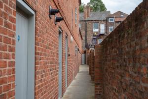 an alleyway between two red brick buildings at The Falcon Tap in York