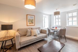 a living room with a couch and a table at The Falcon Tap in York